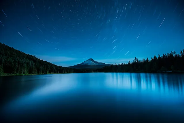 Polaris over Mount Hood, Oregon, US. The north star, Polaris, lines up almost perfectly with Mount Hood and reflects symmetrically in the beautifully serene Trillium lake. The photographer, Garrett Suhrie, used a 20-minute exposure to create the star trails charting the rotation of the Earth, that add further symmetry to the image. (Photo by Garrett Suhrie/National Maritime Museum)