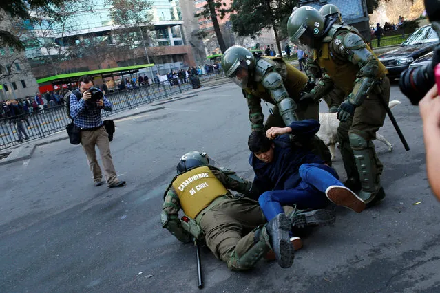 A demonstrator is detained during an unauthorized march called by the Chilean student federations to protest against government's education reform, in Santiago, Chile July 5, 2016. (Photo by Ivan Alvarado/Reuters)