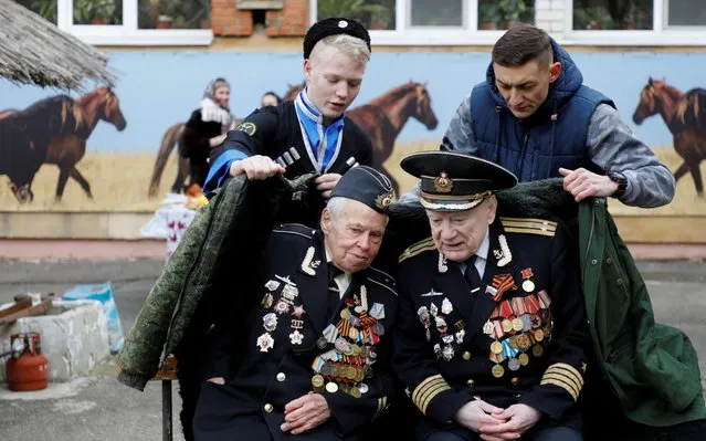 World War Two veterans Viktor Pavlyuchuk and Viktor Sirotkin attend celebrations of Maslenitsa, or Pancake Week, a pagan holiday marking the end of winter, at the General Yermolov Cadet School in southern city of Stavropol, Russia on February 29, 2020. (Photo by Eduard Korniyenko/Reuters)