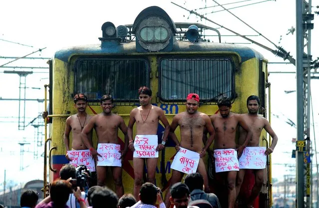 Semi-nude Indian Samajwadi Party student union workers stop a train near Allahabad Junction during a protest against central government in Allahabad on August 11, 2014. The protestors demanded the scrapping of CSAT format in Union Public Service Commission (UPSC) exams. (Photo by Sanjay Kanojia/AFP Photo)