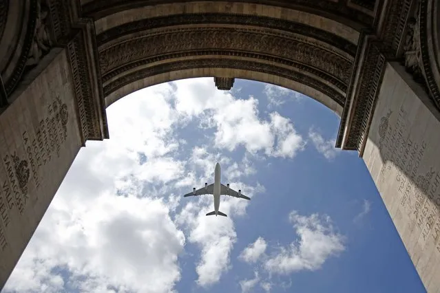The “Esterel”, an Airbus A340 aircraft of the French Air Force, flies above the Arc de Triomphe during a rehearsal of the traditional Bastille Day military parade in Paris, France, July 9, 2015. (Photo by Charles Platiau/Reuters)