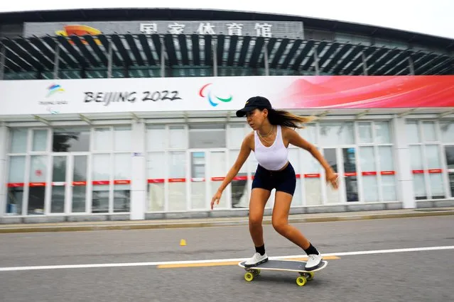 Duo Lan, 31, founder of Beijing Girls Surfskating Community, rides a skateboard during a free weekly training session, outside the National Sports Stadium in Beijing, China on June 19, 2022. (Photo by Tingshu Wang/Reuters)