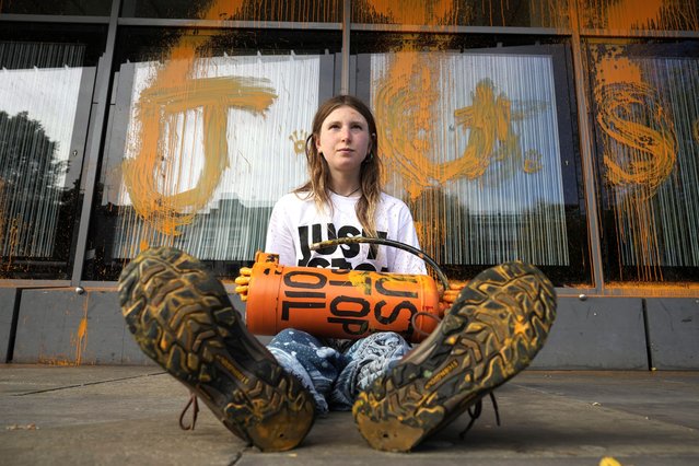 Just Stop Oil protestor Lucy Hammil takes part in a sit down protest after spraying orange paint over the Allen Gilbert Building at Manchester University on October 12, 2023 in Manchester, England. Just Stop Oil have targeted many UK universities claiming that the establishments are accepting money from fossil fuel companies for research and funding. (Photo by Christopher Furlong/Getty Images)