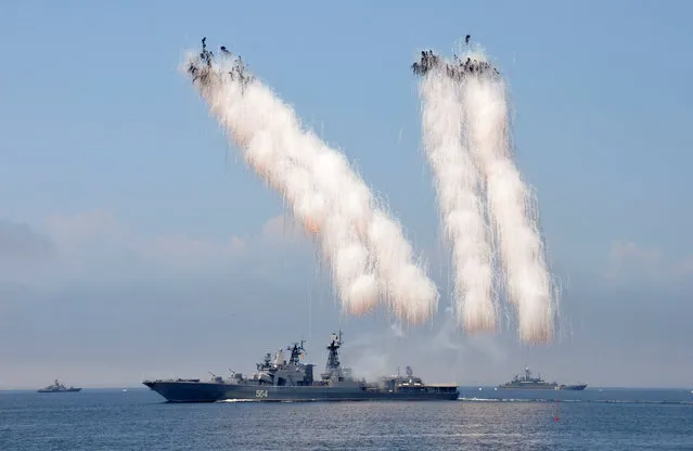 Russian warships sail past exploding anti-missile ordnance during a rehearsal for the Navy Day parade in the far eastern port of Vladivostok, Russia, July 30, 2016. (Photo by Yuri Maltsev/Reuters)