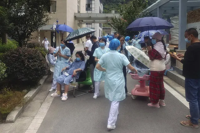 In this photo released by Xinhua News Agency, medical workers transfer patients to safe area at Renmin Hospital of Shimian County in Ya'an City, in the aftermath of an earthquake in southwestern China's Sichuan Province, Monday September 5, 2022. Many people were reported killed in a 6.8 magnitude earthquake that shook China's southwestern province of Sichuan on Monday, triggering landslides and shaking buildings in the provincial capital of Chengdu, whose 21 million residents are already under a COVID-19 lockdown. (Photo by Xinhua via AP Photo)
