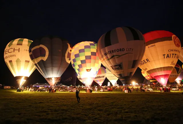 Balloons are illuminated as part of the “nightglow” during the Bristol International Balloon Fiesta in Bristol, Britain August 11, 2016. (Photo by Neil Hall/Reuters)