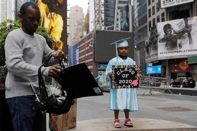 Pre-K graduate Nyah Smith, 4, is prepared for a graduation photo in an almost empty Times Square in Manhattan, New York City, May 24, 2020. (Photo by Andrew Kelly/Reuters)