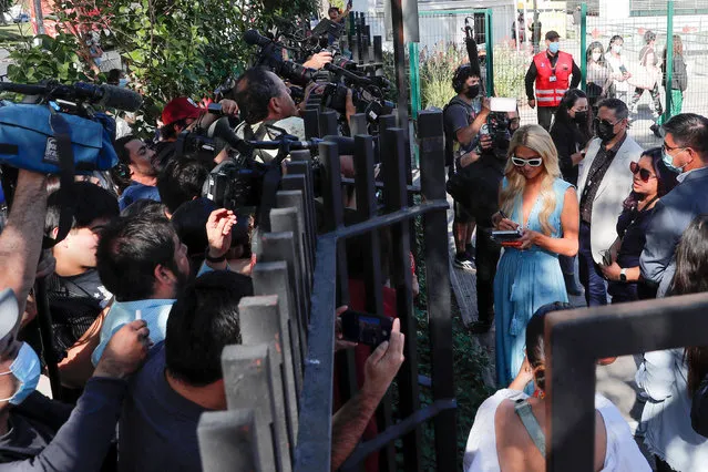 US model and actress Paris Hilton signs an autograph as she arrives at the Teleton Center to meet Chile's TV showman Mario Kreutzberger, better known as Don Francisco, in Santiago, on November 2, 2022. (Photo by Javier Torres/AFP Photo)