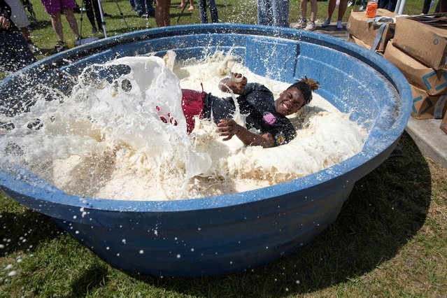Mark Walker jumps into a pool of grits while competing in the grit pit competition during the National Grits Festival in Warwick, Georgia, U.S., April 12, 2025. (Photo by Alyssa Pointer/Reuters)