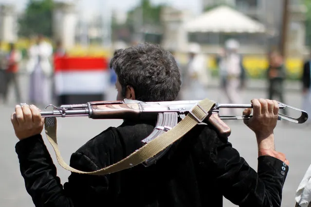 An armed man loyal to the Houthi movement holds his weapon as he gathers to protest against the Saudi-backed exiled government deciding to cut off the Yemeni central bank from the outside world, in the capital Sanaa, Yemen August 25, 2016. (Photo by Mohamed al-Sayaghi/Reuters)