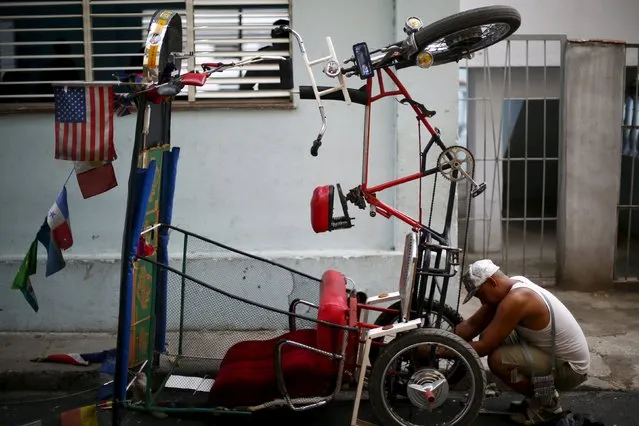 A man repairs his tricycle in Havana, September 18, 2015. (Photo by Edgard Garrido/Reuters)