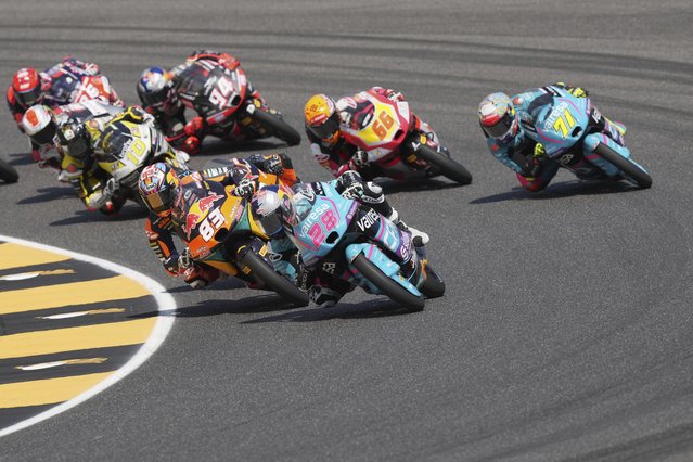 Spain's rider Maximo Quiles of the CFMOTO Gaviota Aspar Team steers his motorcycle followed bySpain's rider Alvaro Carpe of the Red Bull KTM Ajo, left, and Italian rider Dennis Foggia of the CFMOTO Gaviota Aspar Team, right, during the Moto3 race of the Grand Prix of Italy at the Mugello circuit in Scarperia, Italy, Sunday, June 22, 2025. (Photo by Antonio Calanni/AP Photo)