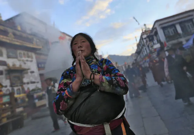 A Tibetan pilgrim prays outside the Jokhang Temple in the early morning in Lhasa, Tibet Autonomous Region, China, 10 September 2016. Jokhang Temple is considered one of the most sacred site for Tibetan buddhists built during the rule of King Songtsen Gampo in the 7th century. (Photo by How Hwee Young/EPA)