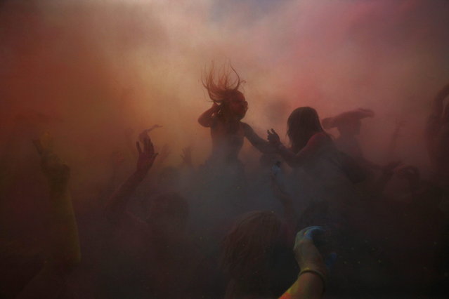 Revellers are covered in coloured cornflour powder as they take part in the Holi One festival in Cape Town, March 2, 2013. The event is inspired by the Hindu Holi spring festival of colour which originated in India. (Photo by Mark Wessels/Reuters)