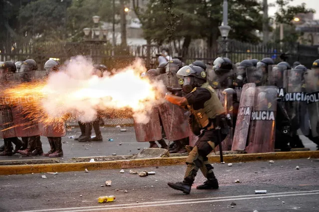 Members of the Police clash with demonstrators during a new day of anti-government protests demanding the resignation of President Dina Boluarte, among other demands, in Lima, Peru, 28 January 2023. The protesters, who have been summoned by social, peasant, union and political organizations, demand the resignation of Boluarte and the closure of Congress, as well as the calling of general elections for this year and a constituent assembly. (Photo by Antonio Melgarejo/EPA/EFE)