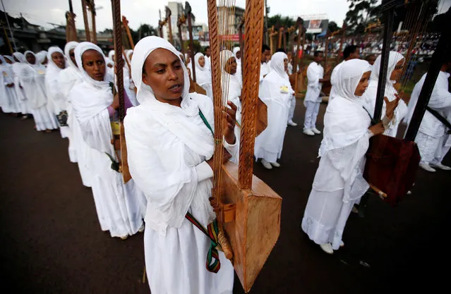 A church choir member plays the harp during the Meskel Festival to commemorate the discovery of the true cross on which Jesus Christ was crucified on at the Meskel Square in Ethiopia's capital Addis Ababa, September 26, 2016. (Photo by Tiksa Negeri/Reuters)