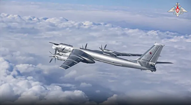 In this handout photo taken from video released by the Russian Defense Ministry Press Service on Wednesday, November 30, 2022, a Tu-95 strategic bomber of the Russian air force flies as part of a joint patrol with Chinese bombers over the Pacific. Russian and Chinese strategic bombers on Wednesday flew a joint patrol over the western Pacific in a show of increasingly close defense ties between the two countries. (Photo by Russian Defense Ministry Press Service via AP Photo)