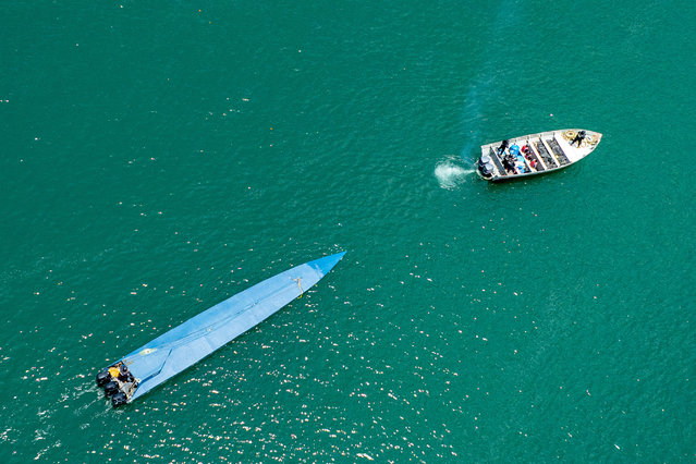 This handout picture released on July 21, 2025, by El Salvador's Presidency Press Office shows members of the Salvadoran Navy escorting a semi-submersible carrying 1.3 tons of cocaine and arresting two Ecuadorians and a Colombian on board, in the shores of San Luis la Herradura, El Salvador. The vessel was intercepted 600 nautical miles (about 1,100 km) southwest of the Bocana El Cordoncillo, Estero de Jaltepeque, and was carrying a cargo valued at “33 million dollars”, El Salvador's President Nayib Bukele said on his account on the social network X. (Photo by Handout/El Salvador’s presidency Press Office via AFP Photo)