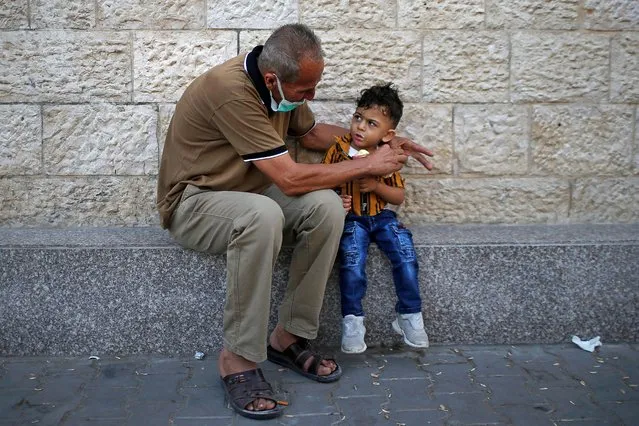 A Palestinian man feeds ice cream to his grandson amid the coronavirus disease (COVID-19) outbreak, in the northern Gaza Strip on September 22, 2020. (Photo by Suhaib Salem/Reuters)