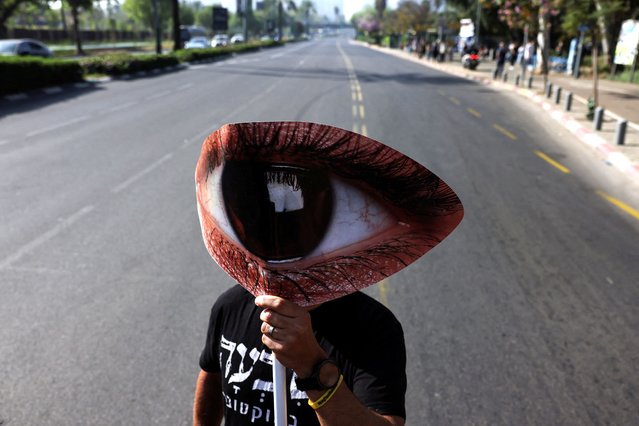 A protester blocks a road to demonstrate demanding the immediate release of hostages, kidnapped during the deadly October 7 attack on Israel by Palestinian Islamist group Hamas from Gaza, in Tel Aviv, Israel, on April 4, 2024. (Photo by Tomer Appelbaum/Reuters)