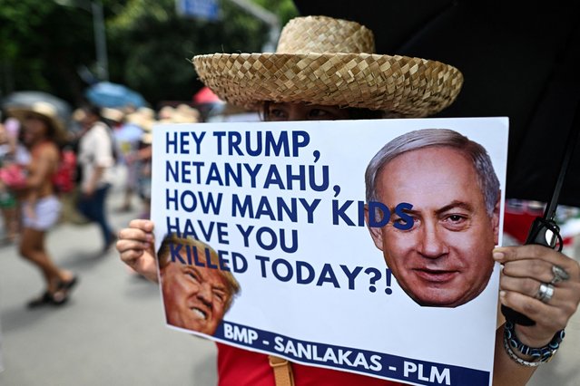 A Filipino activist holds an anti-war poster during a protest near the U.S. Embassy in Manila, Philippines, on June 27, 2025. (Photo by Noel Celis/Reuters)