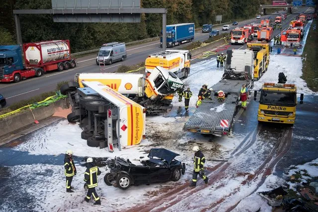 A tanker truck lies overturned on the motorway near Cologne, Germany, October 4, 2016. A police spokesperson provided the information that the driver lost control over his vehicle and collided with another car. (Photo by Marius Becker/EPA)