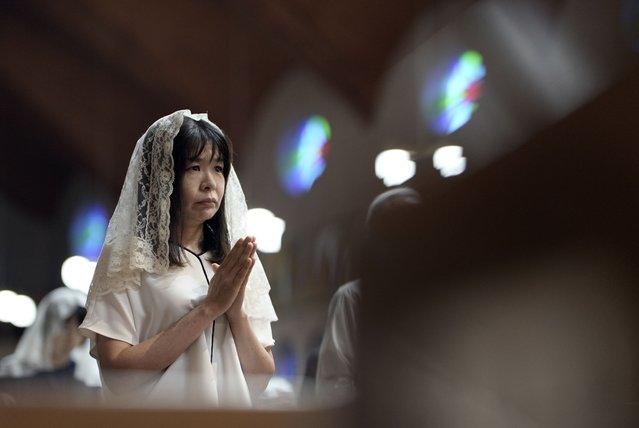 A churchgoer prays during an early morning mass at Urakami Cathedral in Nagasaki, Japan, 09 August 2025, the day of the 80th anniversary of the atomic bombing. In 1945, the United States dropped two nuclear bombs over the cities of Hiroshima and Nagasaki on 06 and 09 August, respectively, killing more than 200,000 people.(Photo by Franck Robichon/ EPA)