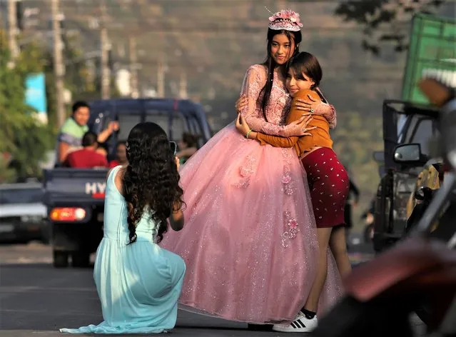 A youth celebrating her 15th birthday, or quinceañera, poses for photos on the main street of La Campanera, during the celebration in an evangelical church in Soyapango, El Salvador, Sunday, March 5, 2023. Even stepping foot on this street would have been unthinkable before the government suspended constitutional rights and started an all out offensive on the gangs one year ago. (Photo by Salvador Melendez/AP Photo)