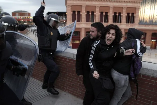 Police clash with demonstrators during a protest near the Spanish Parliament in Madrid, Spain, Thursday April 25, 2013. The protest, mostly against austerity measures, comes on the day that Spain's jobless figures were released. With over 6 million unemployed for the first time ever, Spain’s jobless rate shot up to a record 27.2 percent in the first quarter of 2013, the National Statistics Institute said Thursday, in another grim picture of the recession-wracked country. (Photo by Andres Kudacki/AP Photo)