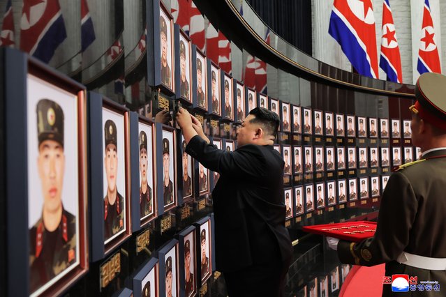 An undated photo released by the official Korean Central News Agency (KCNA) shows North Korean leader Kim Jong Un (C) fixing the “DPRK Hero Medal” beside the portraits of martyrs during a ceremony honoring Korean People's Army (KPA) soldiers who took part in unspecified overseas operations at the headquarters of the Workers' Party of Korea in Pyongyang, North Korea (issued 22 August 2025). According to KCNA, Kim conferred state commendations, including the title of DPRK Hero, to military commanders and martyrs, and met with bereaved families to offer condolences. (Photo by KCNA/EPA)