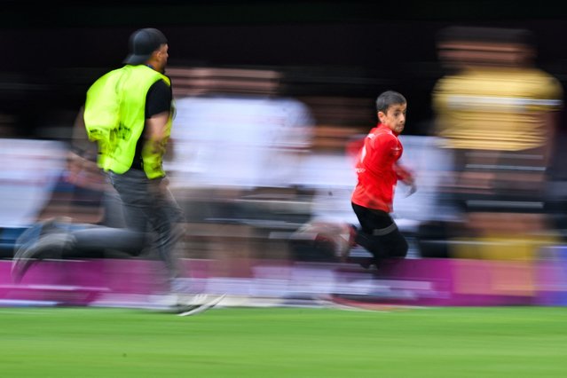 A pitch invader is chased during the UEFA Euro 2024 Group F football match between Turkey and Portugal at the BVB Stadion in Dortmund on June 22, 2024. (Photo by Ina Fassbender/AFP Photo)