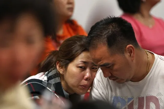 Family of passengers onboard AirAsia flight QZ8501 react at a waiting area in Juanda International Airport, Surabaya December 28, 2014. Indonesia's air force was searching for the AirAsia plane carrying 162 people that went missing on Sunday after the pilots asked to change course to avoid bad weather during a flight from the Indonesian city of Surabaya to Singapore. The Airbus 320-200 lost contact with Jakarta air traffic control at 6:17 a.m. (23:17 GMT), officials said. (Photo by Reuters/Beawiharta)