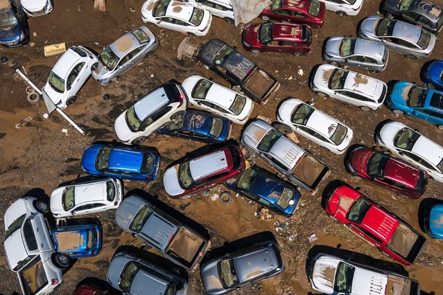 Damaged vehicles sit in mud after flooding in Poza Rica, Veracruz state, Mexico, Sunday, October 12, 2025. (Photo by Felix Marquez/AP Photo)