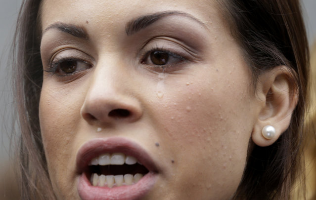 A tear rolls down the cheek of Karima el-Mahroug, also known as Ruby, a Moroccan woman at the center of ex-Premier Silvio Berlusconi's s*x-for-hire trial, as she reads a statement to reporters during a protest outside the court house, in Milan, Italy, Thursday, April 4, 2013. The Moroccan woman at the center of ex-Premier Silvio Berlusconi's s*x-for-hire trial has denounced what she says is psychological warfare being waged against her by Italian prosecutors. Ruby, read out a lengthy statement Thursday to a gaggle of reporters in front of Milan's courthouse denying she was a prostitute and insisting that prosecutors hear her side of the story. (Photo by Luca Bruno/AP Photo)