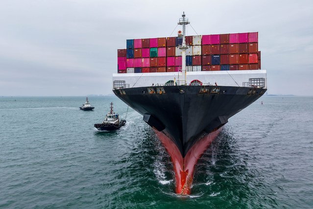 A cargo ship sails into the port in Qingdao, in China's eastern Shandong province on October 13, 2025. China's exports to the United States jumped more than eight percent in September from the previous month, official data showed on October 13, following days of worsening trade tensions between the world's top two economies. (Photo by AFP Photo/China Stringer Network)