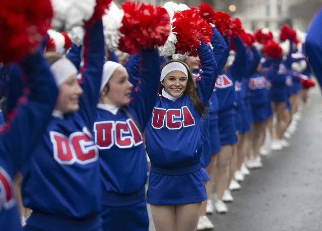 Members of the U.S. Universal Cheerleaders Association wave their pom-poms at the finish of the annual New Year's Day Parade in London January 1, 2015. (Photo by Peter Nicholls/Reuters)
