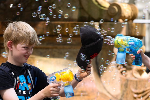 A child sprays bubbles at Bryant Park during a heatwave affecting the U.S. Northeast in New York City on July 17, 2024. (Photo by Kent J Edwards/Reuters)