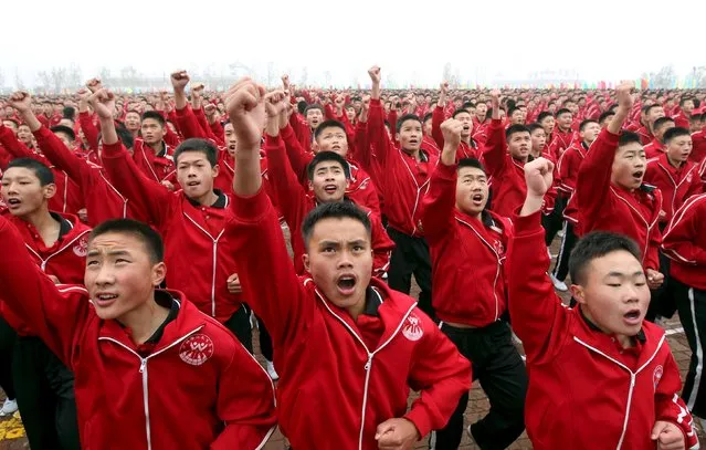 Students perform during a founding ceremony of a football team of Shaolin Tagou martial arts school, in Dengfeng, Henan province, November 10, 2015. (Photo by Reuters/China Daily)