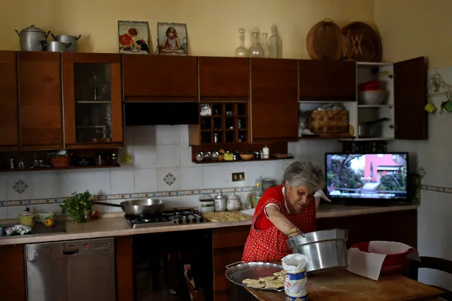 Aida Cicci Cardelli, 90,  cooks for a birthday dinner in the town of Santo Stefano di Sessanio, in the province of L'Aquila in Abruzzo, inside the national park of the Gran Sasso e Monti della Laga, Italy, September 5, 2016. (Photo by Siegfried Modola/Reuters)