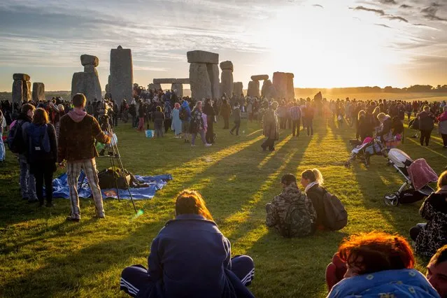 People gather to celebrate the summer solstice at Stone Henge, Wiltshire, England on June 21, 2018. (Photo by Francis Hawkins/South West News Service)