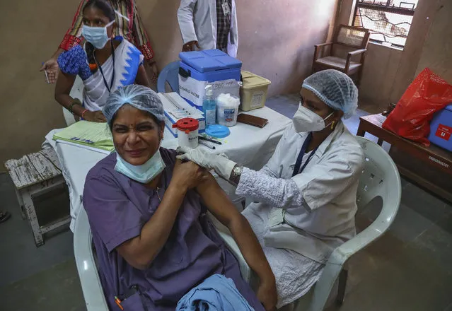 A medical staff receives her second dose of COVID-19 vaccine at a government Hospital in Hyderabad, India, Monday, February 15, 2021. (Photo by Mahesh Kumar A./AP Photo)