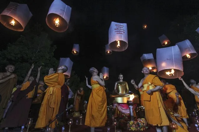 Buddhist monks release lanterns during a Vesak Day procession at Borobudur Temple compound in Magelang, Central Java, Indonesia, Sunday, June 4, 2023. Vesak is the day that marks the birth, death and enlightenment of Buddha. (Photo by Slamet Riyadi/AP Photo)