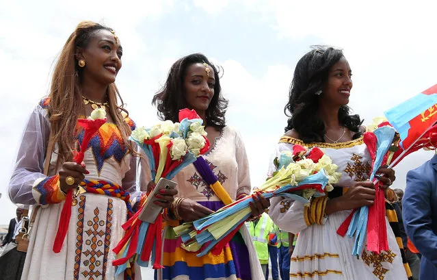 Eritreans wait to welcome their families at Asmara International Airport aboard the Ethiopian Airlines ET314 flight in Asmara, Eritrea on July 18, 2018. Ethiopia and Eritrea on July 18, 2018, resumed commercial airline flights for the first time in two decades, with emotions spilling over into the aisles and onto the tarmac as families were reunited. (Photo by Tiksa Negeri/Reuters)