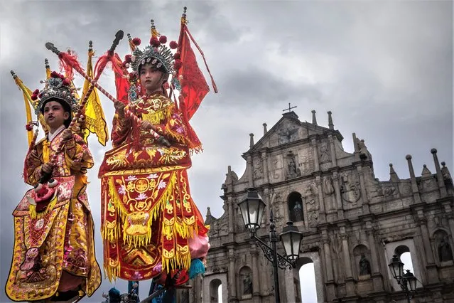 Children dressed as deities take part in a procession in front of the Ruins of St. Paul during celebrations marking the Feast of Na Tcha in Macau on July 4, 2023. (Photo by Eduardo Leal/AFP Photo)