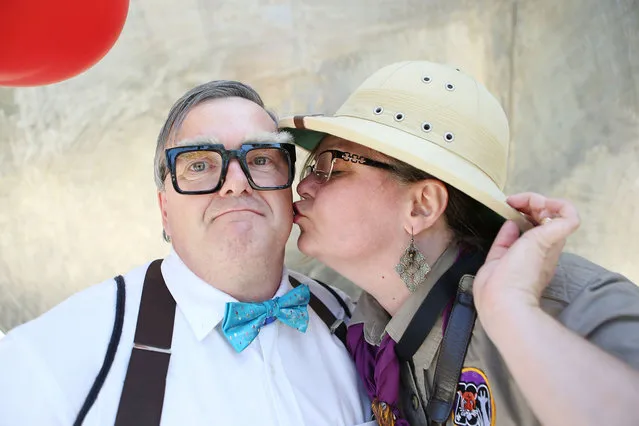 Cosplayers pose dressed as Ellie and Carl from the film “Up” outside San Diego Comic-Con on July 20, 2018 in San Diego, California. More than 100,000 attendees are expected at the annual comic and entertainment convention. (Photo by Mario Tama/Getty Images)