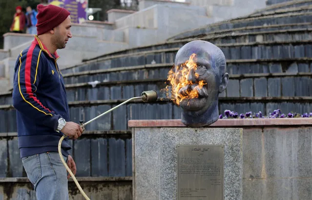 An Iranian artist repairs a statue of famous Iranian painter Kamal-ol-molk at a park in Tehran, Iran, 11 March 2021. According to ISAN news agency, 150,000 doses of Indian COVID-19 vaccine has arrived to the country on 11 March as President Hassan Rouhani was quoted as saying that three kind of Iranian local-made vaccines will be ready soon in summer. Iran has got some COVID-19 vaccine from Russia, China, and India as the country is far from massive vaccination yet. (Photo by Abedin Taherkenareh/EPA/EFE)