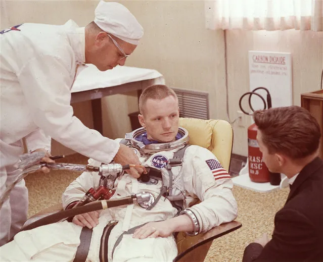 Astronaut Neil Armstrong shown seated during a suiting up exercise March 9, 1966 at Cape Kennedy, Florida, in preparation for the Gemini 8 flight. (Photo by AP Photo)
