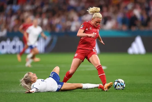Rikke Marie Madsen of Denmark is tackled by Alex Greenwood of England during the FIFA Women's World Cup Australia & New Zealand 2023 Group D match between England and Denmark at Sydney Football Stadium on July 28, 2023 in Sydney, Australia. (Photo by Carl Recine/Reuters)