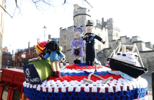 A knitted top cover for a post box depicting Britain's Queen Elizabeth II and her husband Prince Philip in Windsor, England, Friday, April 16, 2021. Prince Philip husband of Britain's Queen Elizabeth II died April 9, aged 99, his funeral will take place Saturday at Windsor Castle in St George's Chapel. The knitted top show some of Prince Philips favorites: the Royal Yacht Britannia, right, the Duke of Edinburgh award scheme for young people and his hobby of carriage driving . (Photo by Alastair Grant/AP Photo)