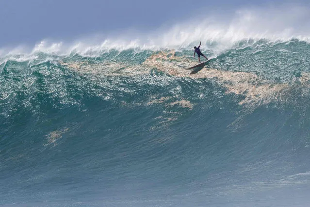 Hawaiian surfer Mark Healy rides a wave during The Eddie Aikau Big Wave Invitational surfing contest on January 22, 2023, at Waimea Bay on the North Shore of Oahu in Hawaii. (Photo by Brian Bielmann/AFP Photo)